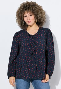 Marinebluse mit rotem Schleifenmuster, langen Ärmeln, V-Ausschnitt und Kordelzug in der Front. Hergestellt aus leichtem Stoff mit gerafftem Bund.
