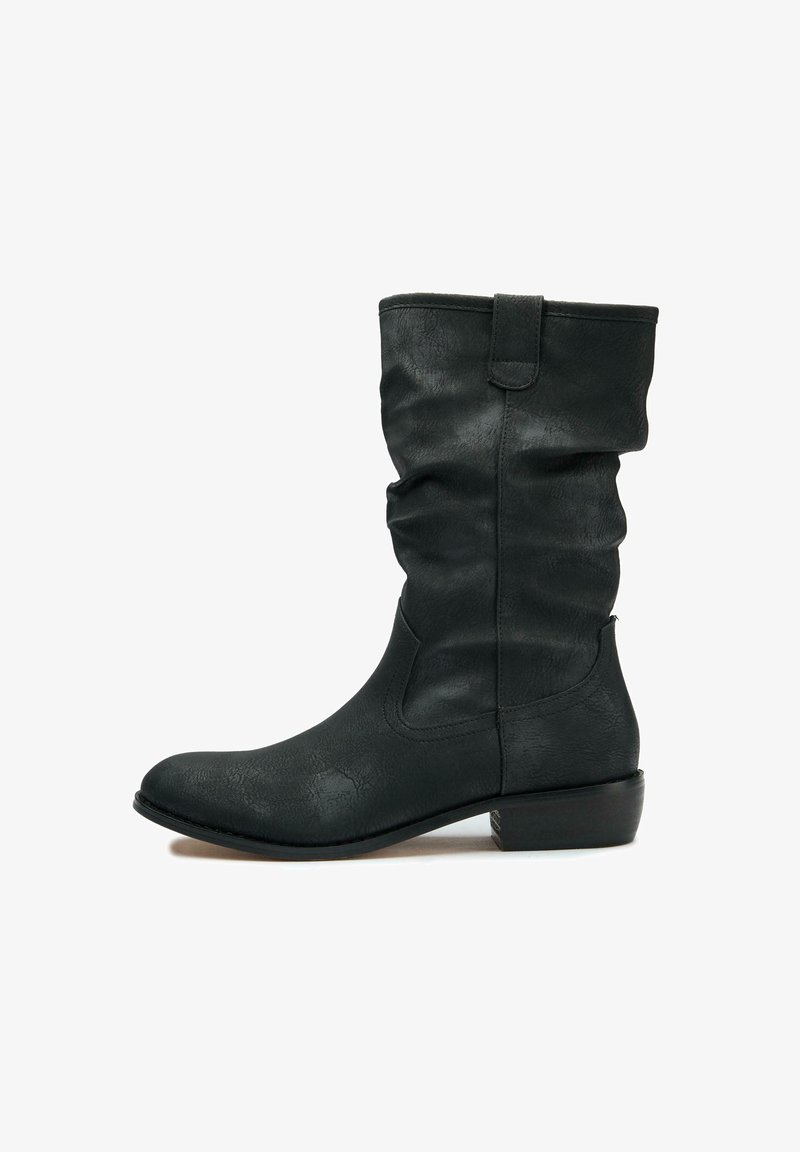 Black ankle boot made of textured faux leather, featuring a slouchy design, rounded toe, low stacked heel, and side seams.