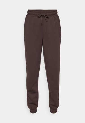 Brune joggebukser med elastisk midje og snor. Har sidelommer og ribbestrikkede mansjetter ved ankelen. Glatt tekstur.