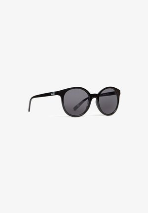 Gafas de sol redondas negras con lentes oscuros y brazos finos que presentan un logo blanco de "VANS" en la patilla. Material de plástico suave.