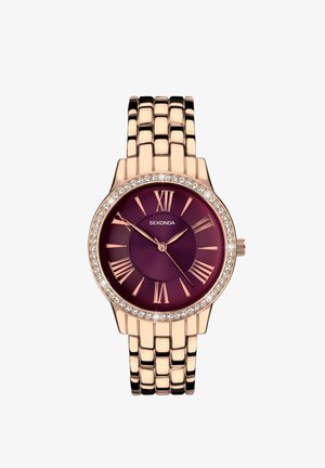 Montre Sekonda avec un cadran rond violet, un boîtier en or rose, des chiffres romains et une lunette ornée de cristaux, montée sur un bracelet à maillons en or rose.
