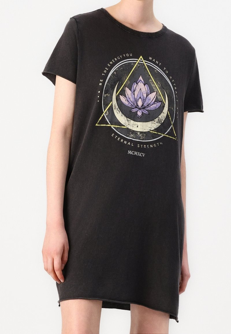 Black cotton t-shirt dress with short sleeves, featuring a graphic print of a lotus and geometric shapes in purple and yellow.