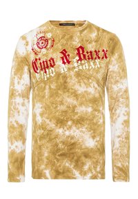 Langarm-T-Shirt in einem hellbraunen und weißen Batikmuster, mit auffälligem roten und weißen Drucktext sowie grafischen Designs auf der Vorderseite.