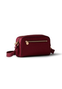 Burgundy textured leather crossbody bag with a gold zipper, adjustable strap, and one exterior zip pocket, rectangular shape.