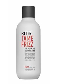 KMS Tame Frizz shampoo in een witte plastic fles, 300 mL. Zwarte dop, vetgedrukte letters in rood en zwart op de voorkant, gladde textuur.