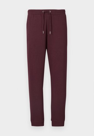 Bordeauxrote Jogginghose aus weichem Stoff mit elastischem Bund, Kordelzug und gerippten Bündchen an den Knöcheln. Keine Taschen.