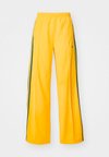 FIREBIRD - Tracksuit bottoms - crew yellow/collegiate green