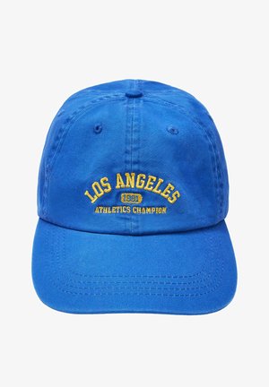 Niebieska czapka bejsbolowa z żółtym haftowanym napisem „LOS ANGELES 1991 ATHLETICS CHAMPION” z przodu na środku.