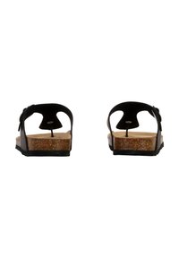 Sort sandal med åben bag, korksål og struktureret bund. Har en sløjfeaccents på remmen. Enkel design med minimale detaljer.
