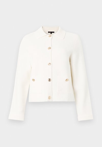 Λευκό τζάκετ με μακριά μανίκια και κουμπιά, γιακά, χρυσά κουμπιά και μία τσέπη στην κάτω δεξιά πλευρά.