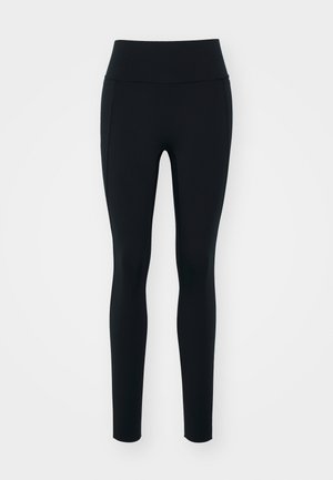 Zwarte leggings van rekbaar materiaal met een hoge tailleband. Soepele textuur, slim fit ontwerp en geen zichtbare versieringen of patronen.