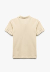 Beżowa koszulka polo z teksturowanym kołnierzykiem i krótkimi rękawami z akcentami z siateczki. Miękki materiał z mieszanki bawełny. Czysty, minimalistyczny design.