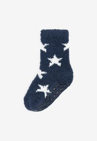 Calcetín esponjoso de color azul marino con un patrón de estrellas blancas, presentando puntos de goma en la parte inferior para mayor tracción. Textura suave en todo su alrededor.