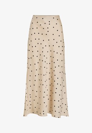 Jupe midi beige en tissu lisse, ornée d'un motif à pois noirs sur l'ensemble, avec une silhouette légèrement évasée et un détail d'un fente.