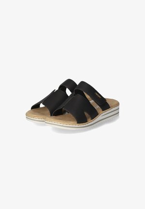 Black slide sandals featuring two wide straps, open toe design, and a cushioned tan footbed with a white and gray striped sole.