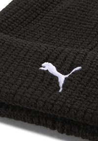 Black knitted fabric with white embroidered Puma logo of a leaping puma centered on the lower portion.