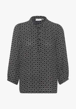 Námornícky top s geometrickým diamantovým vzorom, s výstrihom do stojáčika, so zapínaním na gombíky a trojštvrťovými rukávmi. Mäkká, ľahká tkanina.