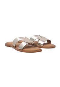 Metalliske guld slide-sandaler med krydsremdesign. Flad sål i brun, tekstureret overmateriale for stil og komfort. Ingen synlig hardware.