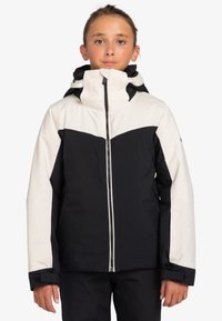 Veste de ski noir et blanc avec un col haut, fermeture éclair à l'avant et poignets ajustables. Présente un grand accent blanc au niveau de la poitrine.