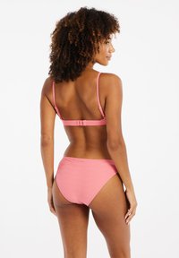 Set di bikini rosa con un motivo geometrico testurizzato, con spalline regolabili e una chiusura sul retro. Il fondo ha un design simile.