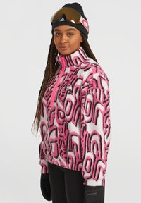 Fleece jacket in pink and white with abstract black patterns, high collar, half-zip front, and ribbed cuffs. Gloves and beanie included.