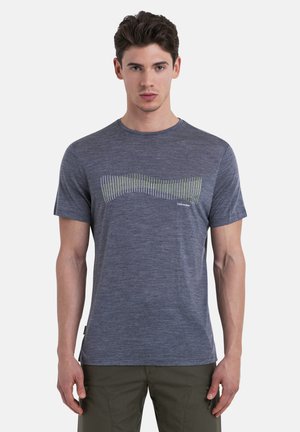 Grey short-sleeve t-shirt made from a soft, textured fabric. Features a wavy graphic pattern in green and white on the front.