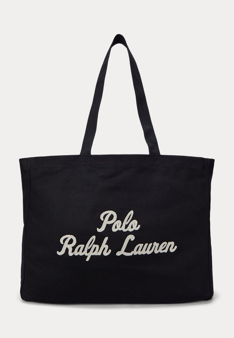 Sac cabas noir avec deux poignées et "Polo Ralph Lauren" brodé en lettres cursives blanches sur le devant.