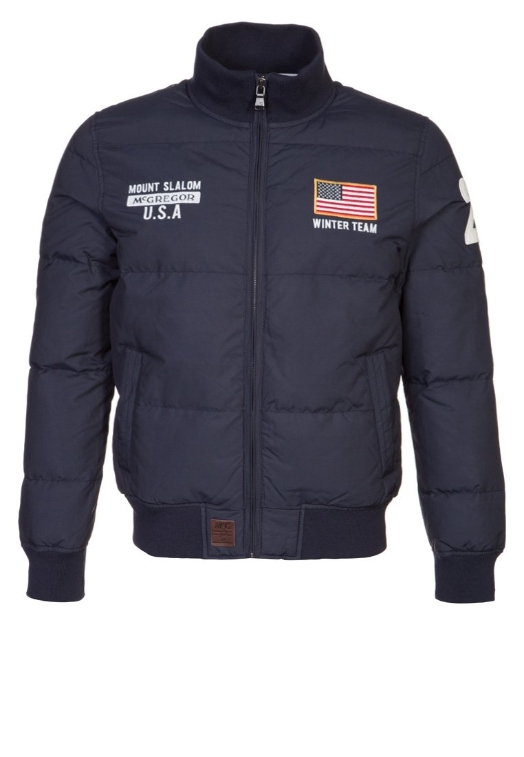 Navy puffer jacket with a high collar, front zipper, embroidered logos, U.S. flag, and ribbed cuffs. Features a padded design for warmth.