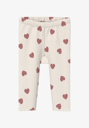 Leggings pour tout-petits en côte crème avec des motifs de cœurs rouges éparpillés et un ourlet ondulé au bas de chaque jambe.