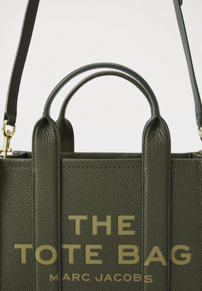 Groene leren tote bag met textuur, voorzien van dubbele handvatten aan de bovenkant en een afneembare schouderriem; bevat een gegraveerd logo en stevige constructie.