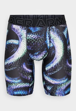 Shorts de compression avec une base noire et un motif imprimé de serpent coloré en bleu et vert. Taille élastique avec le logo "Under Armour".