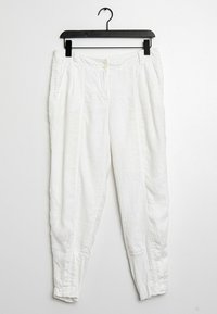 Vita linnebyxor med smal passform, sidofickor, knappstängning och elastiska ärmslut. Slät textur med sydda detaljer längs sömmarna.
