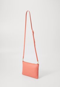 Coral leather crossbody bag with textured surface, adjustable strap, and gold-tone hardware. Rectangular shape, zip closure at the top.