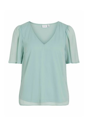 Šviesiai mėtos žalia V formos kaklo palaidinė su trumpomis permatomomis pūstomis rankovėmis ir laisvu siluetu.