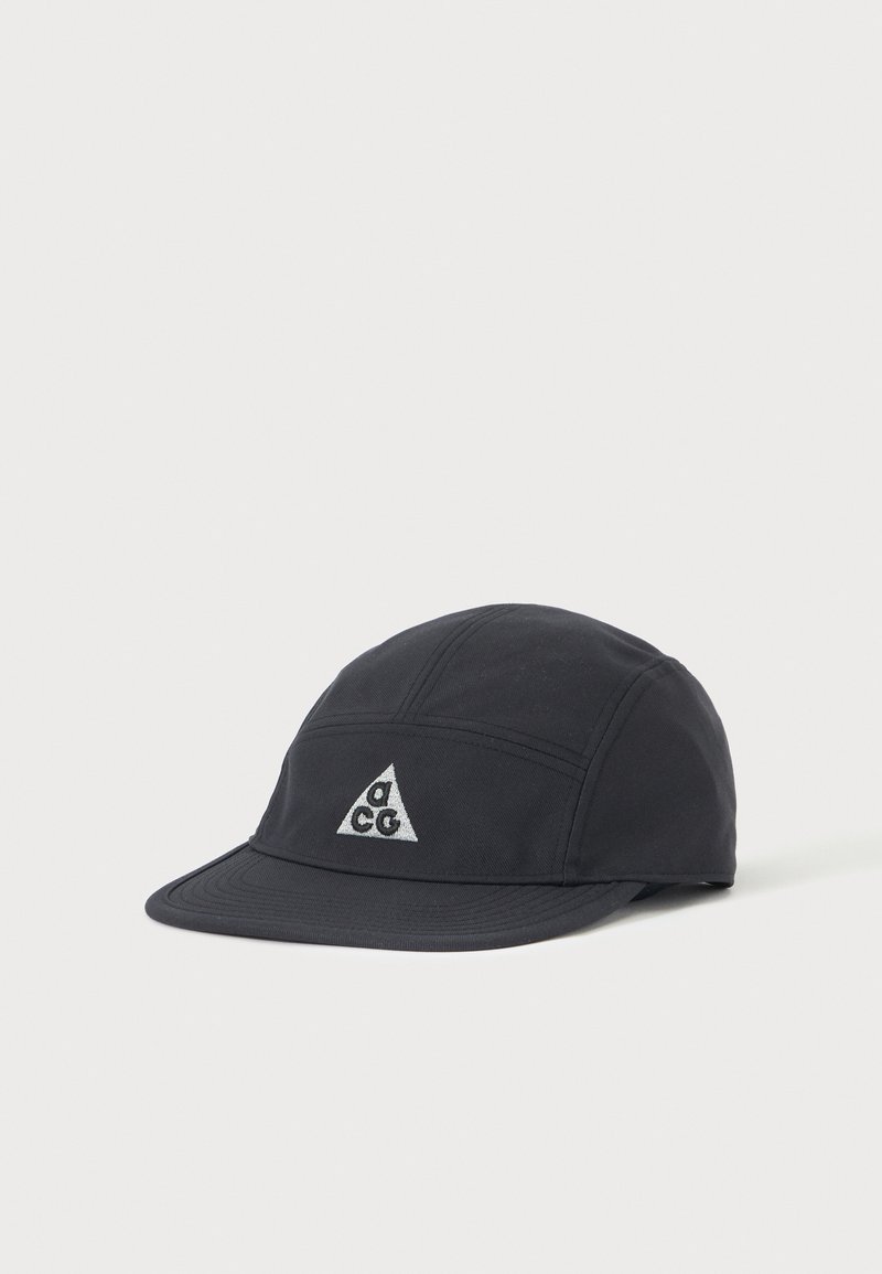 Black fabric cap with a slightly curved brim and a white triangular logo featuring letters on the front center.