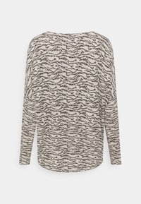 Maglietta a maniche lunghe in tessuto crema con motivo ondulato nero; vestibilità rilassata, orlo arrotondato e scollo a giro.