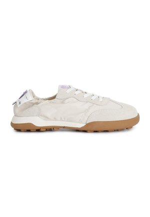 Sneaker with a cream suede and fabric upper, white laces, and a tan rubber sole. Features a soft, padded collar and minimal branding.