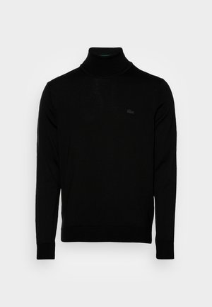 Musternükk, soonik tekstuur, pika varrukaga, keha peale istuv disain, diskreetne Lacoste logo rinnas, keskmise kaaluga kudumismaterjal.