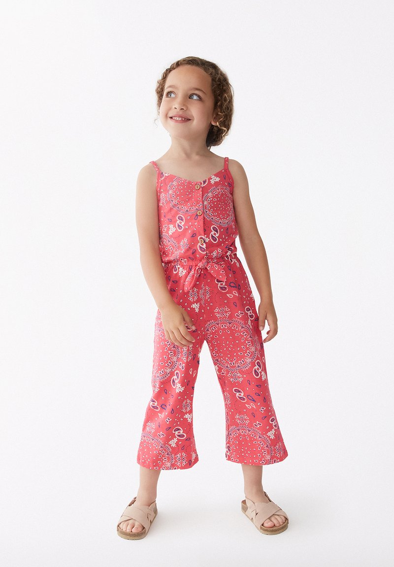 Jumpsuit rojo con estampado, tirantes finos, cintura ceñida y piernas acampanadas cortas. Presenta botones en la parte delantera y diseños florales.