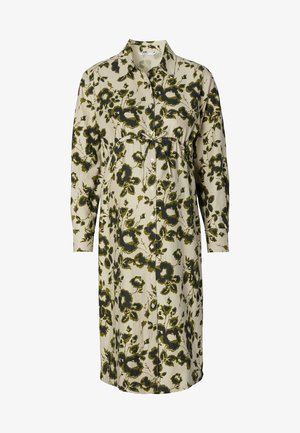 Bloemen shirtjurk in crème en groen, met lange mouwen, een knoopsluiting aan de voorkant en een aansluitende taille met een strikdetail. Zachte katoenen stof.