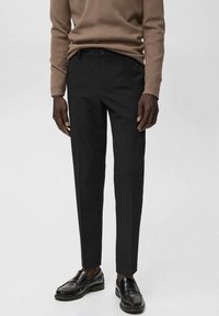 Pantalones negros ajustados con un corte recto, hechos de una tela suave. Cuentan con una cinturilla estándar, trabillas para cinturón y bolsillos laterales.