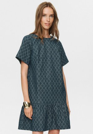 Dark blue dress with short sleeves, diamond pattern, and ruffled hem. Made of textured fabric, featuring a round neckline and loose fit.