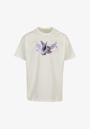 Maglietta di cotone color crema con una grafica di un uccello in volo, caratterizzata da accenti color lavanda e un design circolare intorno.