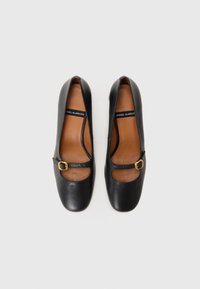 Black leather shoes with a square toe, Mary Jane design, featuring a gold buckle accent and cut-out detail on each side. Brown inner lining.