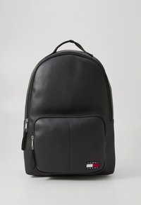 Zaino nero realizzato in materiale sintetico liscio. Presenta una parte superiore arrotondata, una tasca frontale con zip e un logo marchiato con accenti rossi, bianchi e blu.