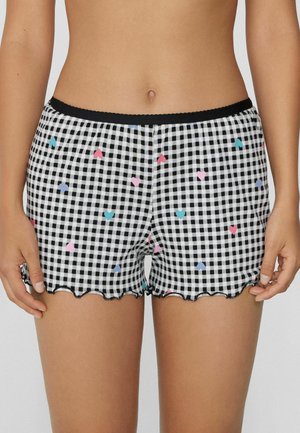 Corti a quadri bianco e nero con orlo a scallop, decorati con motivi di cuori colorati in rosa, blu e azzurro. Vita elasticizzata.