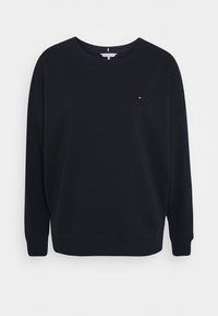 Sudadera azul marino con cuello redondo, mangas largas y puños de canalé. Presenta un pequeño logo en el lado izquierdo del pecho. Material suave de algodón.