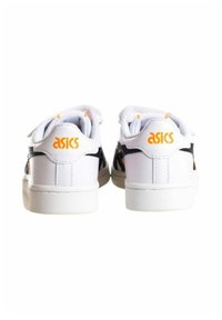Zapatillas deportivas blancas con un upper de cuero liso, acentos negros, logo naranja en el talón y una suela de goma texturada.