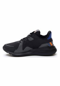 Black athletic shoe featuring a textured rubber sole, mesh upper, grey overlays, and blue and orange accents on the heel.
