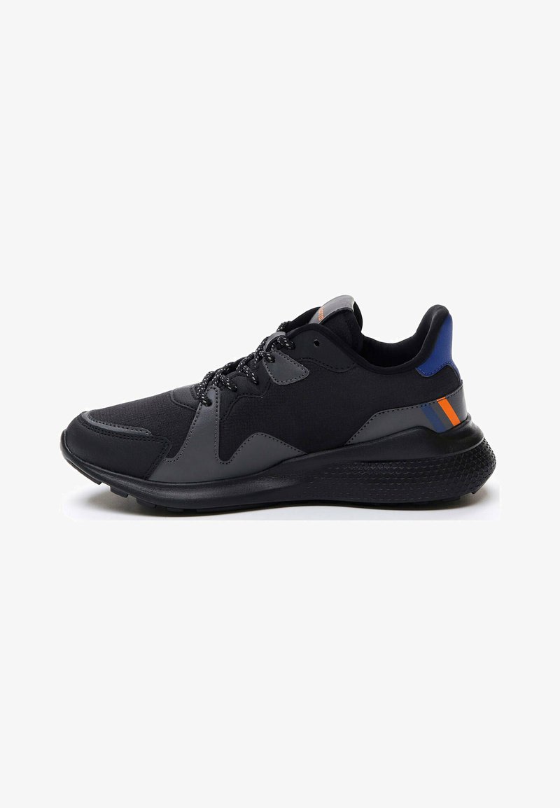 Black athletic shoe featuring a textured rubber sole, mesh upper, grey overlays, and blue and orange accents on the heel.